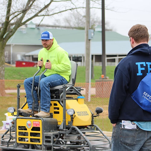 A concrete demonstartion for two students at the 2019 Construction Career Day