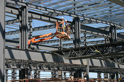 Septagon employees working on a steel building