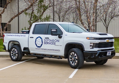 A white truck with the Septagon Services logo on the side